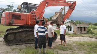 foto : Polma Gurning, (Kaos Putih celana pendek), memberi arahan kepada salah satu tokoh masyarakat, untuk bersama memperbaiki jalan jalan yang rusak penghubung dua desa,  yakni desa Riniate dan desa Parmonangan, kabupaten Samosir.