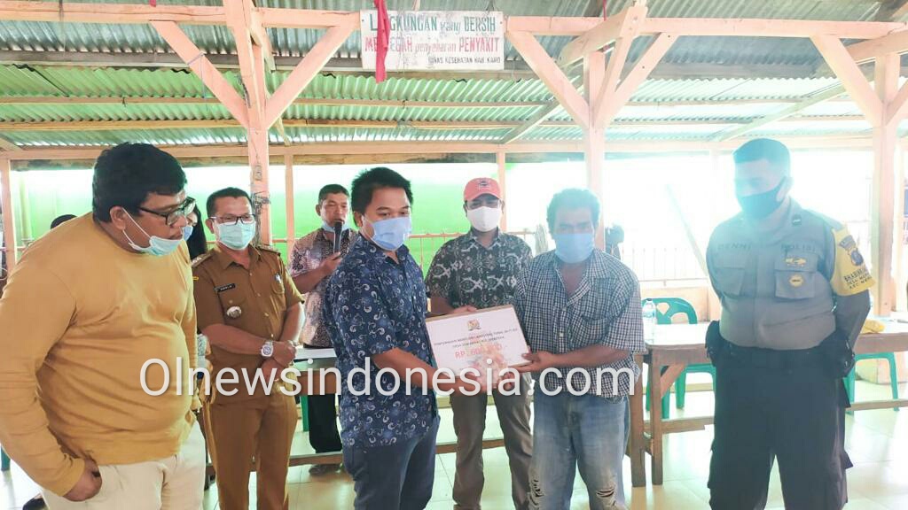 Ket foto : tampak Kades Desa Semangat Kecamatan Merdeka Kabupaten Karo Resmando Sinulingga menyerahkan BLTDD di saksikan Camat Merdeka Oberlin Sembiring dan Anggota DPRD Karo di Lost (Aula) Desa Semangat Raja Payung, Selasa (02/06) 2020 (Ist)